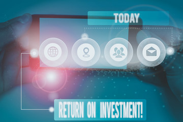 Conceptual hand writing showing Return On Investment. Concept meaning perforanalysisce measure used evaluate efficiency of investment Picture photo network scheme with modern smart device