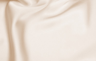Fototapeta premium Draped satin beige fabric for festive backgrounds