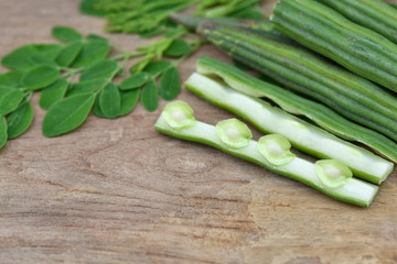 Moringa oleifera, Moringa leaves and Moringa seed Healthy green vegan super food- Fresh harvested organic Moringa [ drum stick } vegetable  on wood background. Selected focus