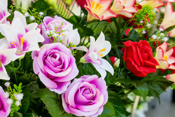 closeup of colorful artificial flowers exposed in the street