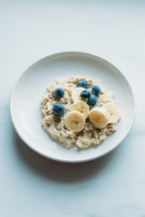 Healthy Breakfast, Blueberry Oatmeal on marble background with copy space