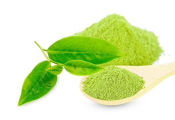 powdered green tea with wooden spoon , isolated on white background