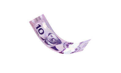 Vancouver, Canada: March 23, 2019: Canadian dollar bills presented as flying in the air, isolated...