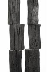 Natural wood charcoals isolated on white background.