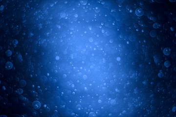 Blue bokeh dark background. Bubbles under the ocean With copy space