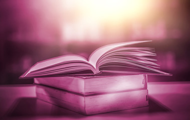 The blurred book that is bewitched with magic, the magic light in the dark, with the bright light shining down as the power to search for knowledge. For research and use as a blurred background