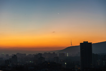 Naklejka na ściany i meble Dramatic sunrise over Tbilisi downtown