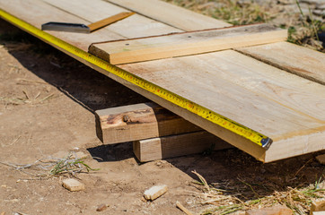 yellow measuring tape measures the formwork boards