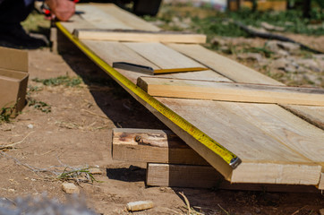 yellow measuring tape measures the formwork boards