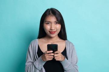 Young Asian woman with mobile phone.