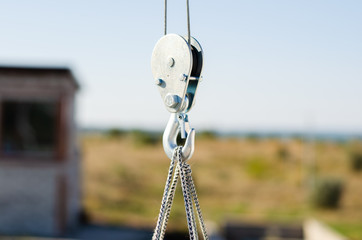 electric winch hook lifts load on cables