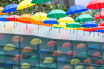 Colorful umbrellas background. Multicolored umbrellas hanging above the street. 
