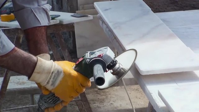 a master shaves the marble edges