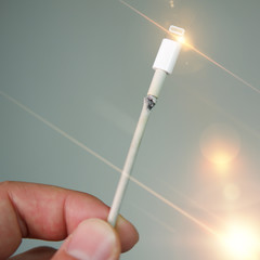 Close-up of broken smartphone's charger cable
