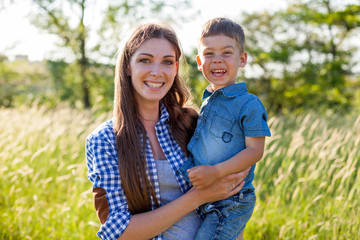 mom with her son on a picnic in the woods in nature