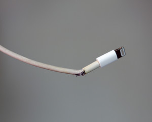 Close-up of broken smartphone's charger cable