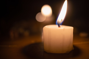 Large white lighted candle close-up. concept of magic, divination.