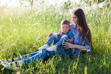 mom with her son on a picnic in the woods in nature