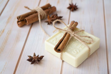Organic soap with cinnamon on wooden background