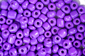 Round purple beads for making jewelry shot large on a white background