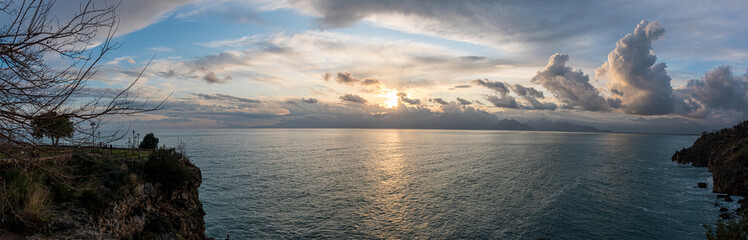 Beatiful panoromic seascape at sunset with dramatic clouds on mediterranean sea, panaroma  of sunset