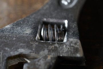 Adjustable wrench isolated on wooden background . Macro photography