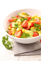 bowl of tomato, avocado and corn salad