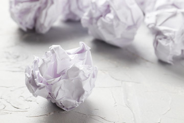 Crumpled paper balls on a light background. Close-up.