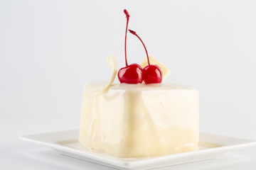 Cake on plate with cherry