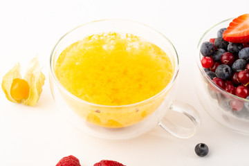 Fruits and berry yellow tea in two cups