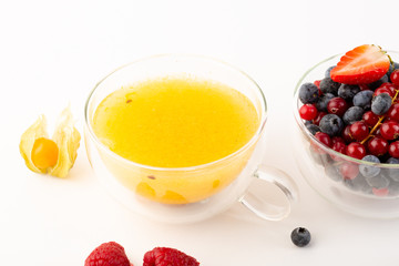 Yellow sea buckthorn tea on white background