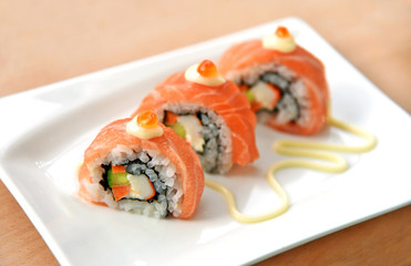 Homemade Uramaki  California roll sushi with mayonnaise on white dish