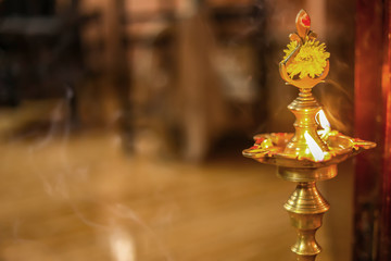 Traditional south indian brass oil lamp 'Nilavilakku '. During events like housewarming, This...