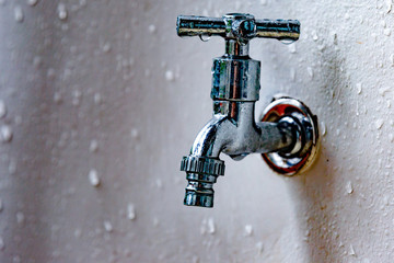 Fototapeta na wymiar gray metal faucet close up wet covered drops. Crane water head adjustment