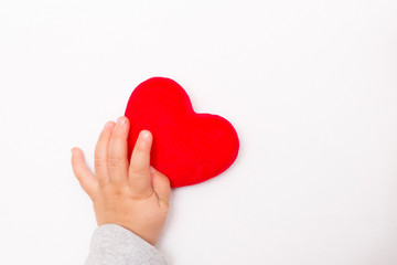 red heart in the children's arm, white background