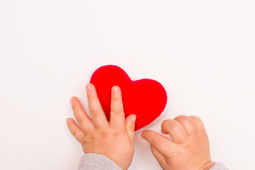 Fototapeta premium heart in babys hand isolated on white background, copy space