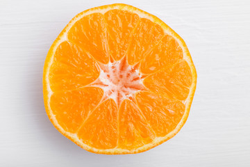 Freshly cut mandarin orange fruit half, closeup shot