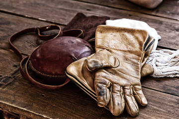 leather gloves old beige weathered protection falconry hip flask close-up