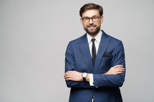 studio photo of young handsome stylish businessman wearing suit