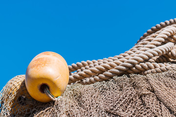 Fishing nets with buoy and rope. Marine background. Nautical photo.