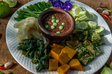 Thai Traditional Food : Spicy Shrimp Paste Dip or Fried shrimp paste sauce (Nam Prik Kapi) with blanched vegetables and cha-om omelets.