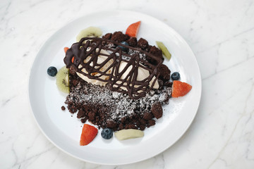 Chocolate crumble, Vanilla ice creams on chocolate cookies  crumbles with blueberries,  strawberries and kiwis