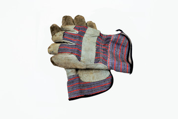 Used and worn work gloves on a white background.