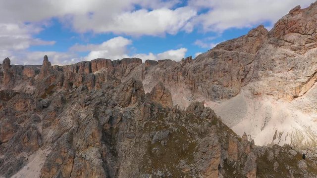 Aerial view of the Paso Gardena Pass in the province of Bolzano. Dolomites. Flying near the Pizes de Cir. In the distant view of a mountain Schelrn. Autumn in Italy