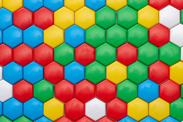 background texture of mosaic, plastic in the shape of hexagons. multicolored abstract photo. red blue yellow red white colors. child Game