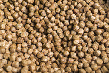Close up brown small pellets feed the fish