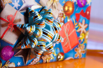 Fototapeta na wymiar Bow on the gift blue with gold stripes for the background