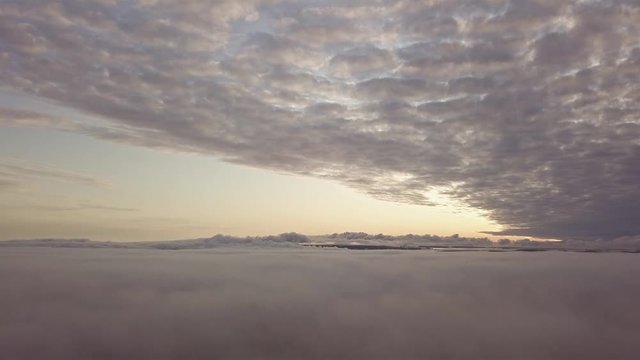 Aerial mornig view between layers of fog and clouds