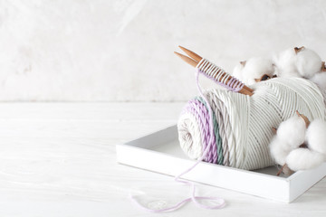 Cotton yarn, the beginning of knitting, knitting needles. White background.
