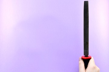The file is sandwiched with the back of the palm, pointing upwards.